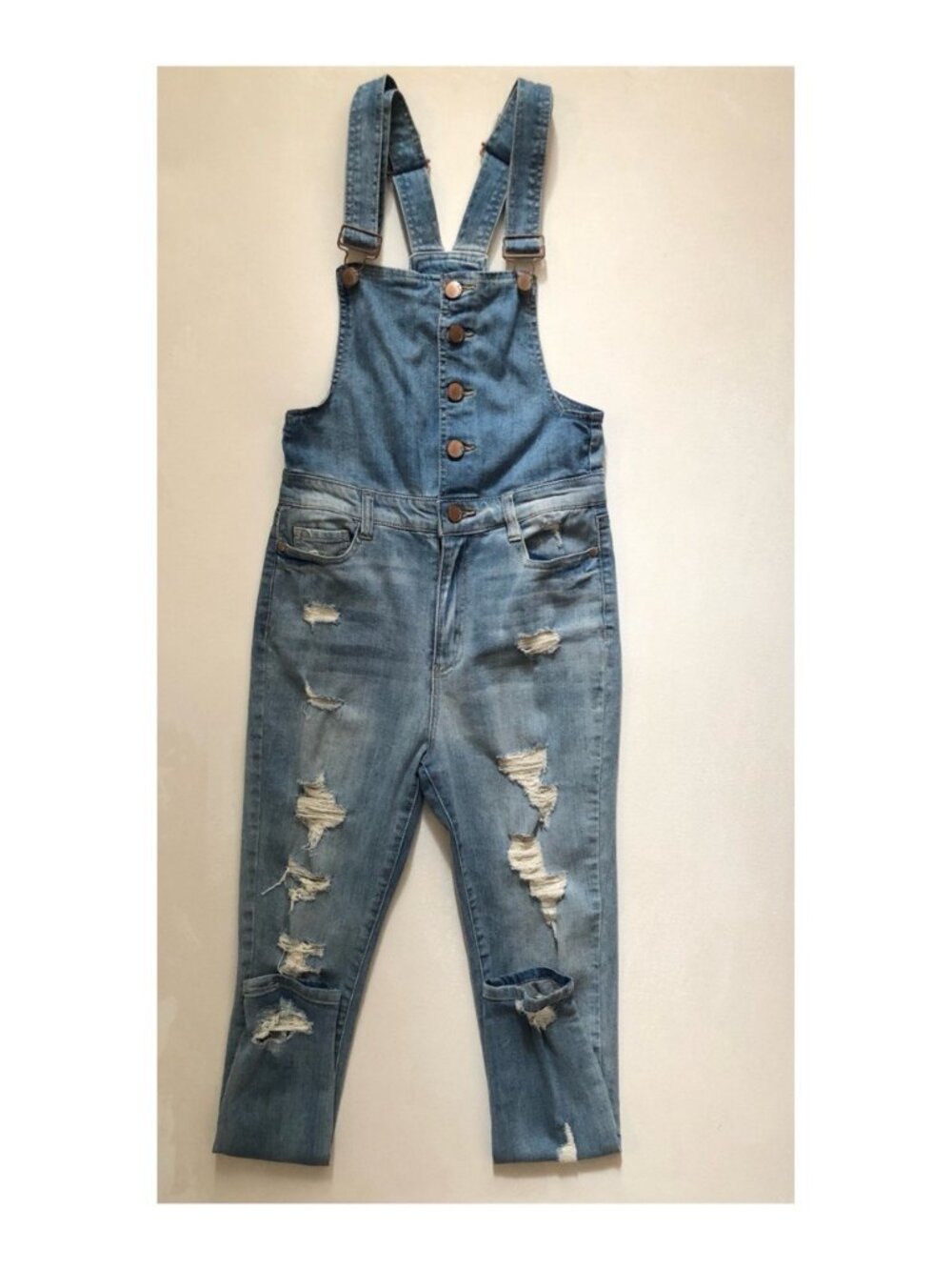 Distressed denim overalls